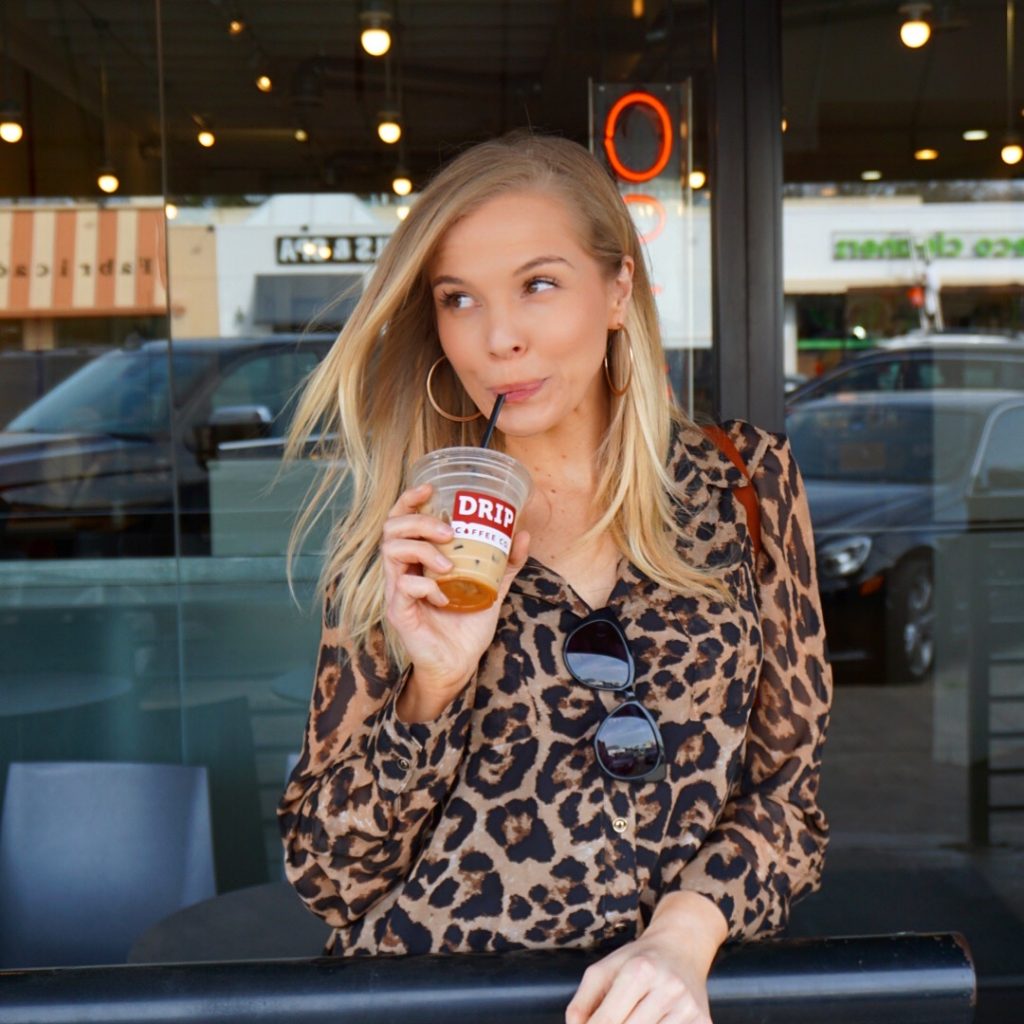 Me wearing leopard print long sleeved button down sheer blouse from Amazon Fashion at Drop Coffee Co in Dallas, TX