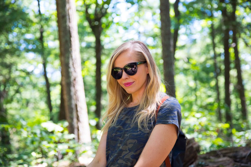 Girl wearing black Zenni cat eye prescription sunglases in the woods