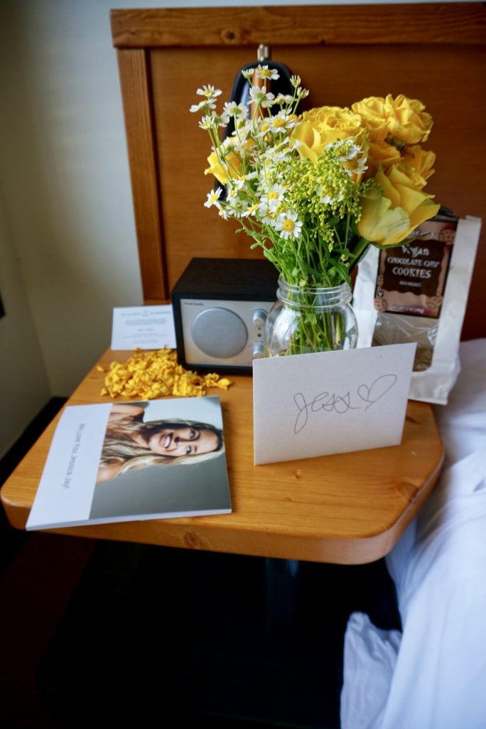 Jessica Jays bachelorette party decorations yellow flowers and photo book in the hotel room